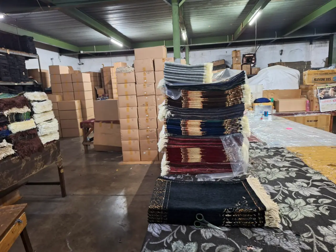 Stacked high-quality finished chenille prayer mats and rugs ready for wholesale export inspection
